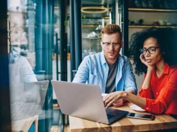 man and woman with lap top tracking progress towards goals